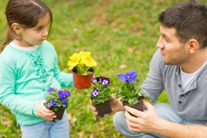 Father and daughter with lawn & garden supplies
