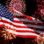 July 4th fireworks in front of American flag